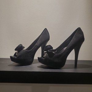 Black platform heels with toe box embellishment